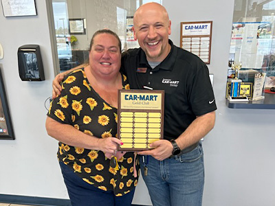Kimberly and Brennon with the Gold Club plaque