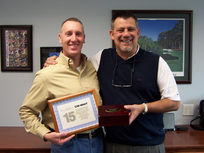Brian receiving his 15 year certificate from Eddie Hight, retired COO