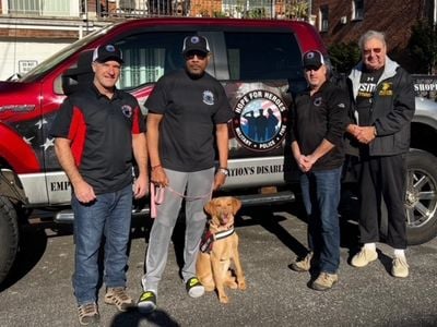 It was a momentous day when Mychal Watts received his canine companion. Here (L-R) are Joe Chorba, K9 Trainer; Mychal and Connie; Mitch Serlin, K9 Trainer and President of Hope for Heroes; and the late Ed Schloeman, Founder and President of Operation Warrior Shield.